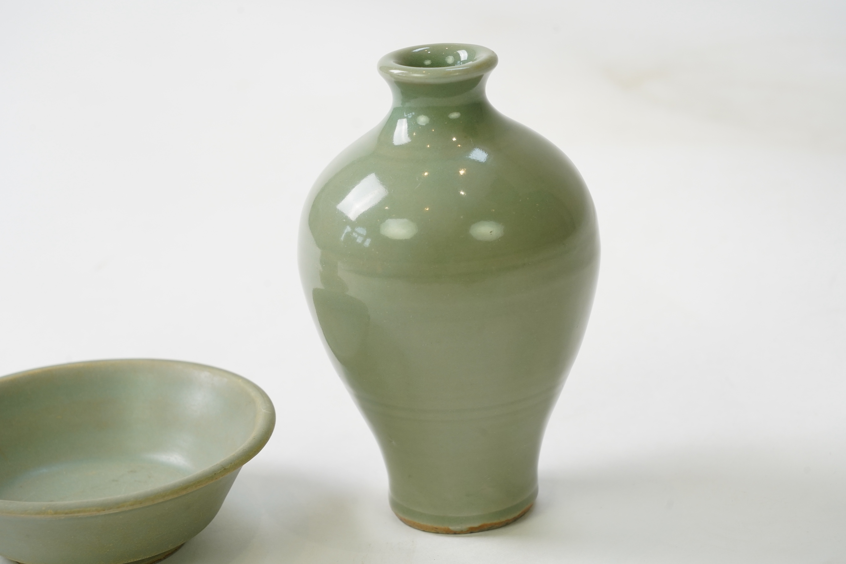 A group of four Chinese Celadon wares - two vases and two dishes, tallest vase 16cm.